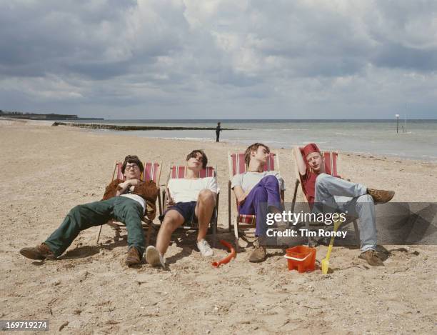 English alternative rock band Blur relax on a beach, circa 1995. From left to right, Graham Coxon, Alex James, Damon Albarn and Dave Rowntree.