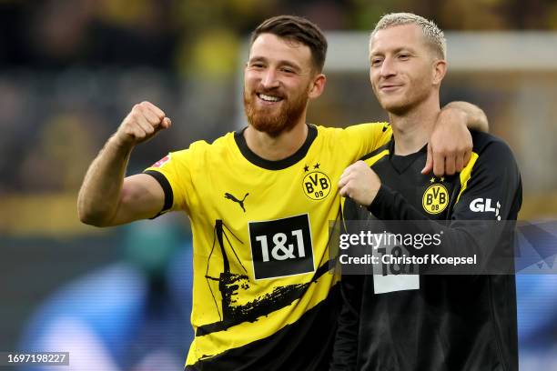 Salih Oezcan and Marco Reus of Dortmund celebrate after winning 1-0 the Bundesliga match between Borussia Dortmund and VfL Wolfsburg at Signal Iduna...