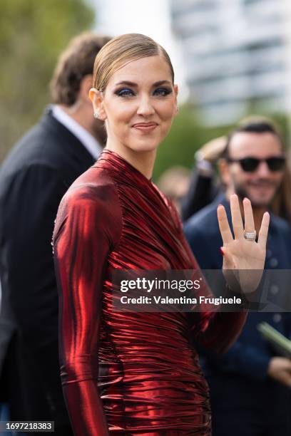 Chiara Ferragni is seen wearing blue eyeshadow and a red lycra long sleeves dress outside the Ferragamo show during the Milan Fashion Week -...