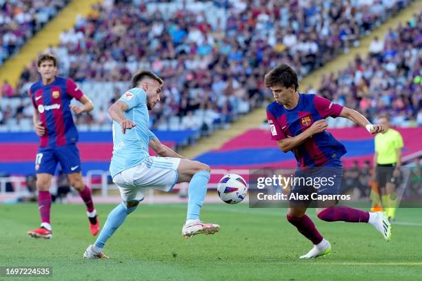 Oscar Mingueza of Celta Vigo battles for possession with Joao Felix of Barcelona during the LaLiga EA Sports match between FC Barcelona and Celta...