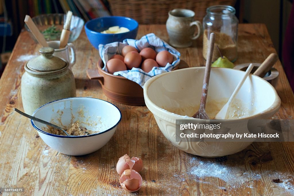 A kitchen table in the middle of baking