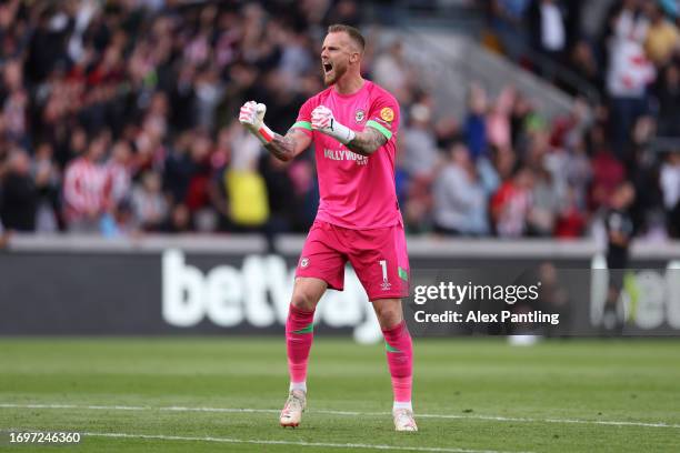 Mark Flekken of Brentford celebrates after Mathias Jensen of Brentford scores their sides first goal during the Premier League match between...