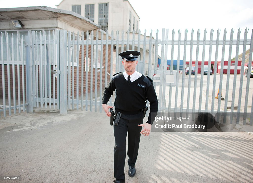 Security guard standing in front of gate
