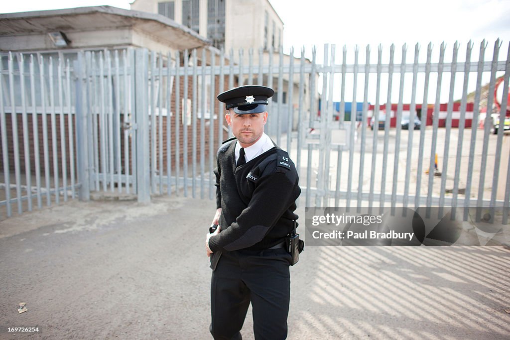 Security guard standing in front of gate