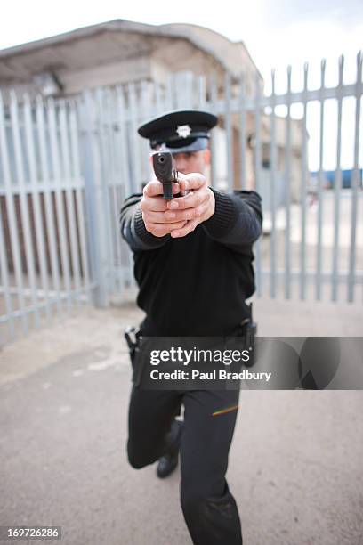 security guard pointing gun - paul gun stock pictures, royalty-free photos & images