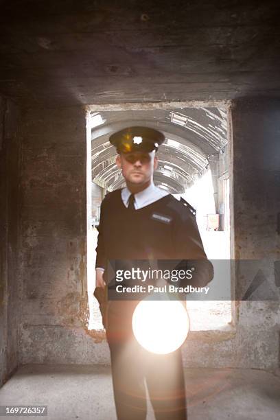 security guard with flashlight checking bunker - flashlight stock pictures, royalty-free photos & images