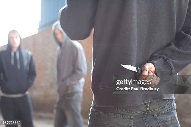 two men being confronted by man with knife - stealing crime 個照片及圖片檔