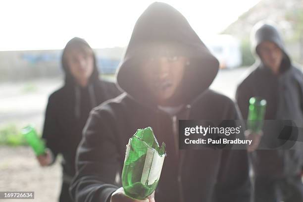man wielding broken bottle - hooligan stock pictures, royalty-free photos & images