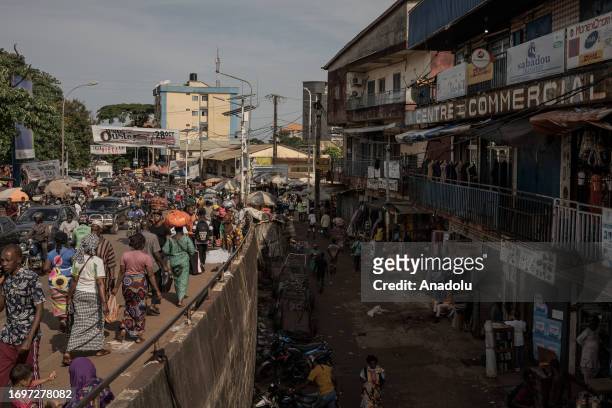 People walk on a crowded street as daily life continues in Conakry, Guinea on September 28, 2023. Guinea, like other African countries, is rich in...