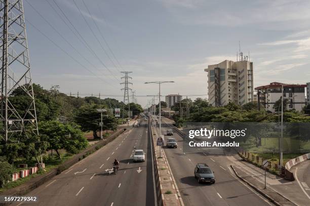 Vehicles pass by on the road as daily life continues in Conakry, Guinea on September 28, 2023. Guinea, like other African countries, is rich in...