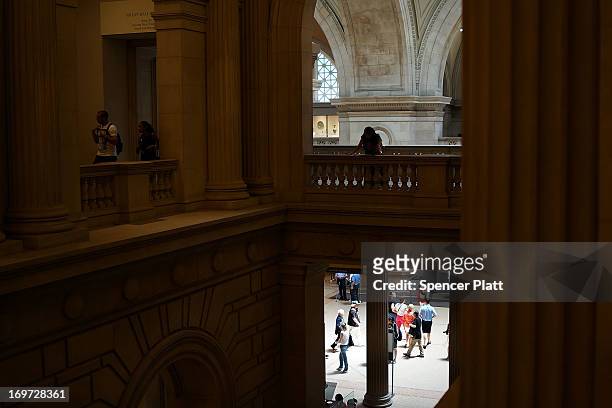 People walk through galleries at the Metropolitan Museum of Art on May 31, 2013 in New York City. Many New Yorkers and tourists alike flocked indoors...