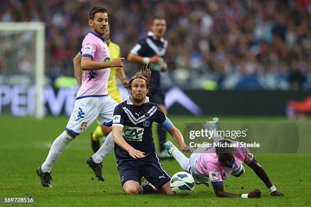 Jaroslav Plasil of Bordeaux falls under the challenge of Mohammed Rabiu of Evian Thonon Gaillard during the French Cup Final match between Evian...