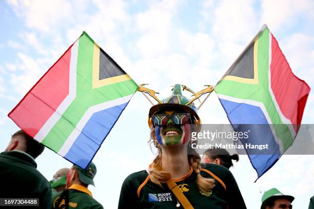 Fan of South Africa, wearing a builders hat decorated with Springboks and the National Flag of South Africa, looks on whilst wearing Face Paint and...