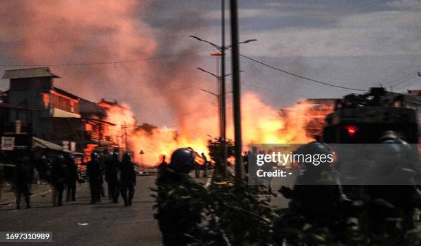 In this photo taken on September 28 demonstrators burn tyres as they protest near the family home of chief minister N Biren Singh, in Imphal in...