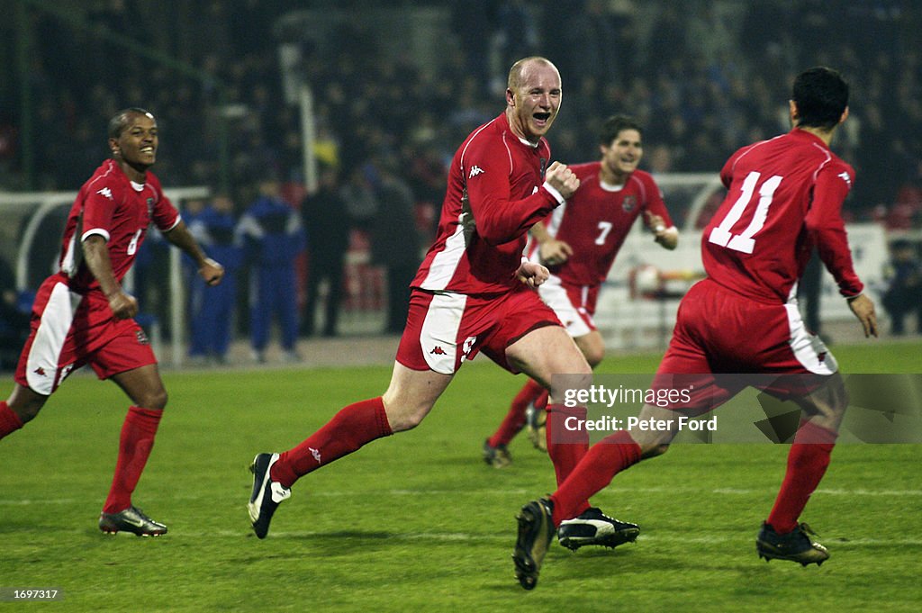 John Hartson of Wales celebrates scoring Wales second goal