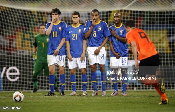 Netherlands' striker Robin van Persie takes a free kick as Brazil's midfielder Kaka, Brazil's striker Nilmar, Brazil's midfielder Gilberto Silva and...