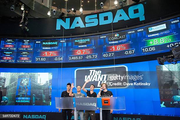 Tom Parker, Max George, Jay McGuiness and Siva Kaneswaran of the band The Wanted rings The NASDAQ Stock Market Closing Bell at NASDAQ MarketSite on...