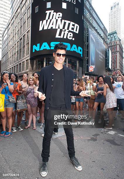 Siva Kaneswaran of the band The Wanted rings The NASDAQ Stock Market Closing Bell at NASDAQ MarketSite on May 31, 2013 in New York City.