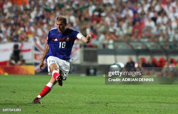 French captain Zinedine Zidane shoots and scores France's equaliser against England, 13 June 2004 during their opening match at the European Nations...