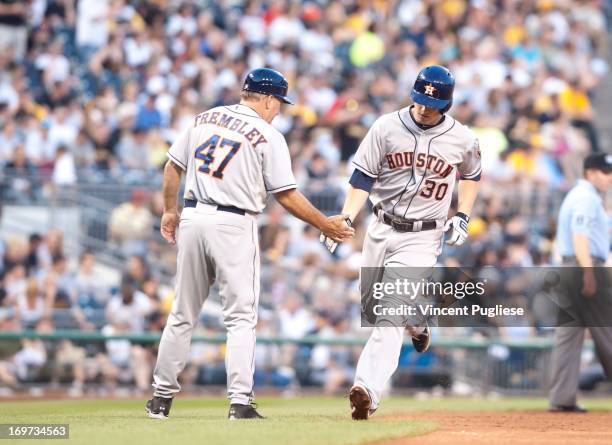 Matt Dominguez of the Houston Astros is congratulated by third base coach Dave Trembley after hitting a home run in the fifth inning at PNC Park on...