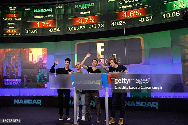 Siva Kaneswaran, Max George, Tom Parker and Jay McGuiness of The Wanted rings The NASDAQ Stock Market Closing Bell at NASDAQ MarketSite on May 31,...