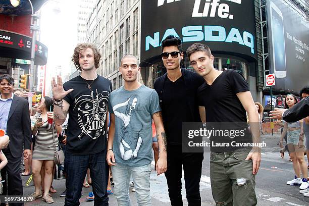 Jay McGuiness, Max George, Siva Kaneswaran and Tom Parker of The Wanted rings The NASDAQ Stock Market Closing Bell at NASDAQ MarketSite on May 31,...