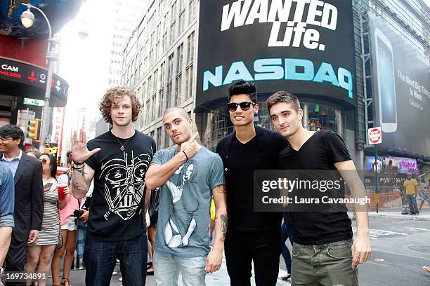 Jay McGuiness, Max George, Siva Kaneswaran and Tom Parker of The Wanted rings The NASDAQ Stock Market Closing Bell at NASDAQ MarketSite on May 31,...