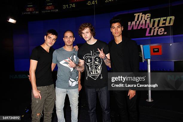 Tom Parker, Max George, Jay McGuiness and Siva Kaneswaran of The Wanted rings The NASDAQ Stock Market Closing Bell at NASDAQ MarketSite on May 31,...