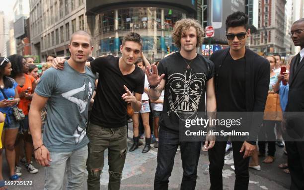 Singers Max George, Tom Parker, Jay McGuiness and Siva Kaneswaran of The Wanted ring the closing bell at the NASDAQ MarketSite on May 31, 2013 in New...
