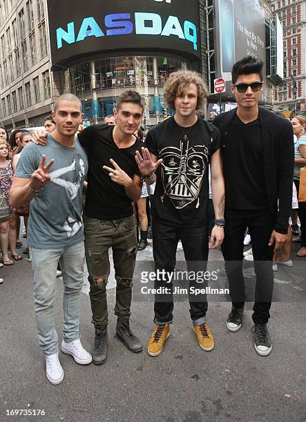 Singers Max George, Tom Parker, Jay McGuiness and Siva Kaneswaran of The Wanted ring the closing bell at the NASDAQ MarketSite on May 31, 2013 in New...