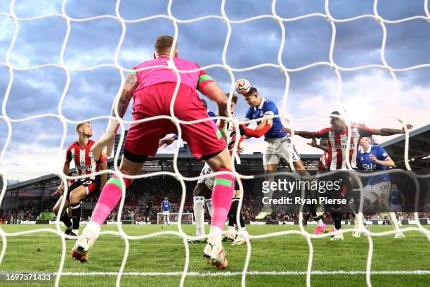 James Tarkowski of Everton scores their sides second goal past Mark Flekken of Brentford during the Premier League match between Brentford FC and...
