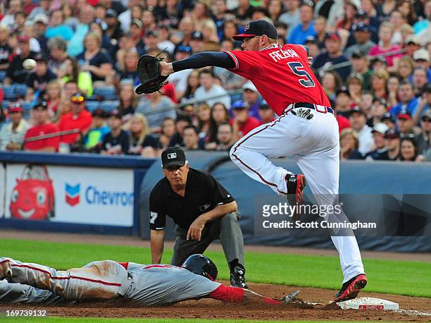 Freddie Freeman of the Atlanta Braves takes a throw at first base to force out Denard Span of the Washington Nationals at Turner Field on May 31,...