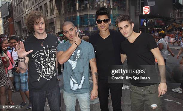 Singers Jay McGuiness, Max George, Siva Kaneswaran and Tom Parker of The Wanted ring the closing bell at the NASDAQ MarketSite on May 31, 2013 in New...