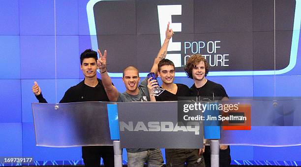 Singers Siva Kaneswaran, Max George, Tom Parker and Jay McGuiness of The Wanted ring the closing bell at the NASDAQ MarketSite on May 31, 2013 in New...