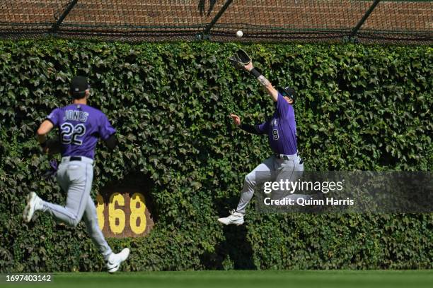 Brenton Doyle of the Colorado Rockies jumps to catch the fly ball by hit by Seiya Suzuki of the Chicago Cubs in the first inning at Wrigley Field on...