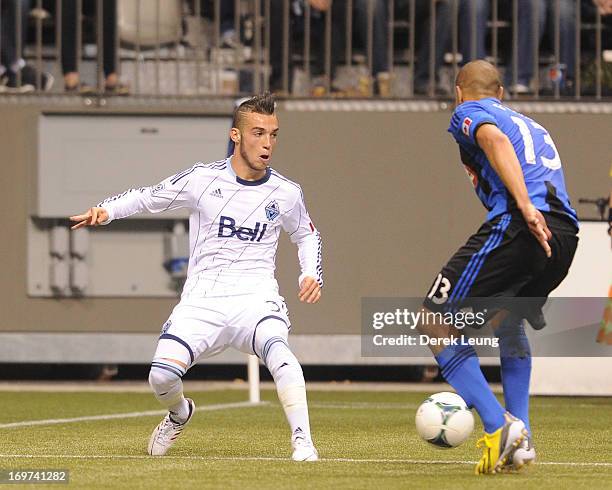 Russell Teibert of the Vancouver Whitecaps looks to check Matteo Ferrari of the Montreal Impact during the finals of the Amway Canadian Championship...