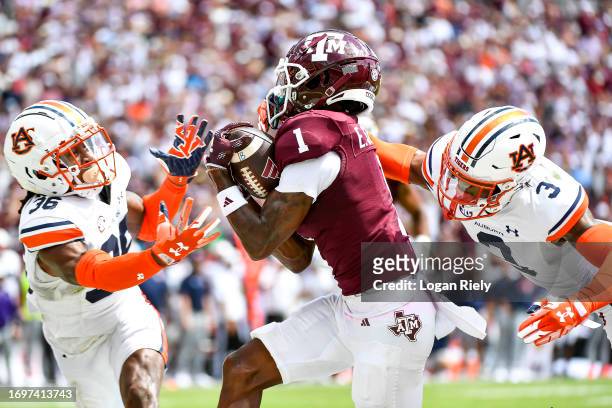 Wide receiver Evan Stewart of the Texas A&M Aggies catches a pass for a touchdown in the second half against the Auburn Tigers at Kyle Field on...