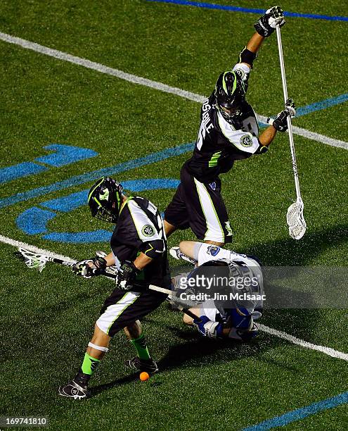 Steve Waldeck and CJ Costabile of the New York Lizards defend against Peet Poillon of the Charlotte Hounds during their Major League Lacrosse game at...