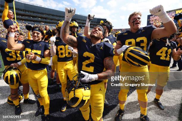 Blake Corum of the Michigan Wolverines celebrates a 31-7 win over the Rutgers Scarlet Knights with teammates at Michigan Stadium on September 23,...