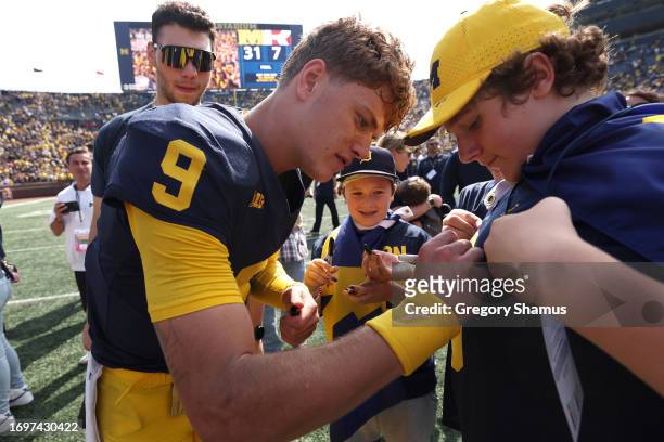 McCarthy of the Michigan Wolverines signs a autograph after a 31-7 win over the Rutgers Scarlet Knights at Michigan Stadium on September 23, 2023 in...