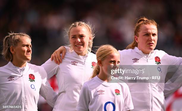 Rosie Galligan, Cath O’Donnell and Claudia MacDonald of England line up for the national anthems ahead of the Women's International match between...