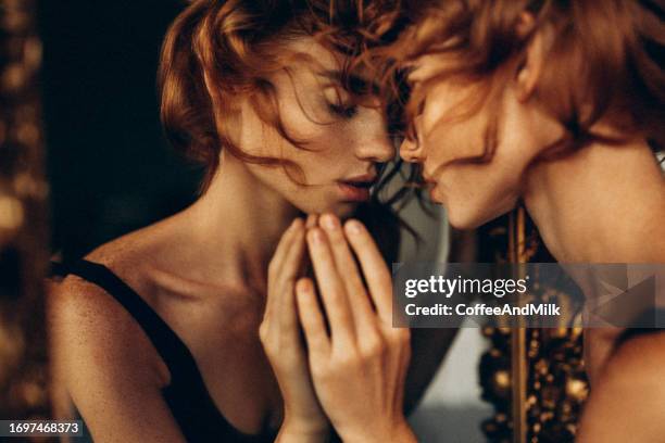 photo of a sensual woman in the dark looking at reflection - art from the shadows stock pictures, royalty-free photos & images