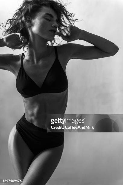 photo of a sensual woman in the dark. black and white - women fashion model stock pictures, royalty-free photos & images