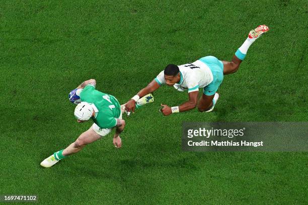 Mack Hansen of Ireland scores his team's first try whilst under pressure from Manie Libbok of South Africa during the Rugby World Cup France 2023...