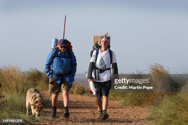 Dr Charlie Gardner is joined for a few days on his walk by Robert Possnett and Lola during a walk to highlight climate change on September 29, 2023...