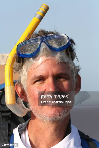 Dr Charlie Gardner wearing a snorkel to highlight the danger of rising sea levels during a walk to highlight climate change on September 29, 2023 in...