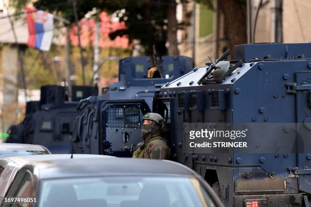 Police officer looks on as Kosovo police officers search a restaurant and building in northern Serb-dominated part of ethnically divided town of...