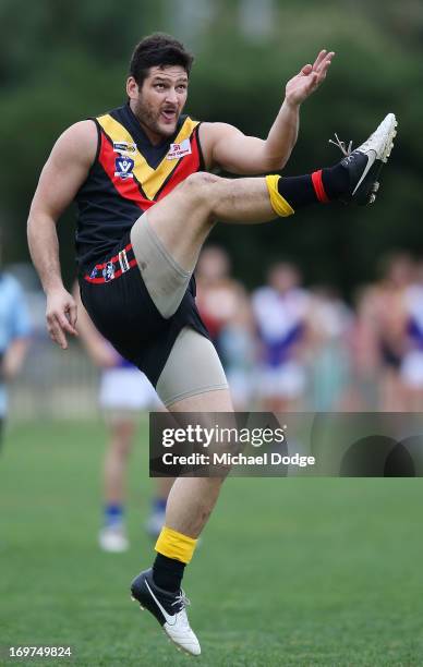 Brendan Fevola of Bacchus Marsh kicks the ball during the round six BFL match between Bacchus Marsh and Sunbury at Maddingley Park on June 1, 2013 in...