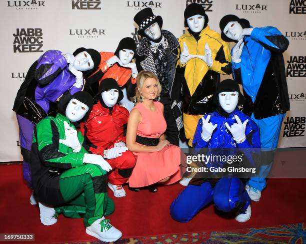 Members of the Jabbawockeez dance crew pose with model and television personality Holly Madison at the grand opening of their show "PRiSM" at the...