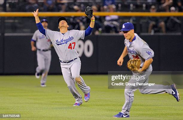 Shortstop Luis Cruz of the Los Angeles Dodgers calls out a fly ball against the Colorado Rockies at Coors Field on May 31, 2013 in Denver, Colorado....